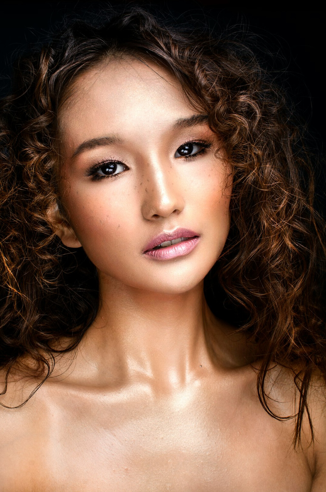 Studio portrait of a young woman with curly hair