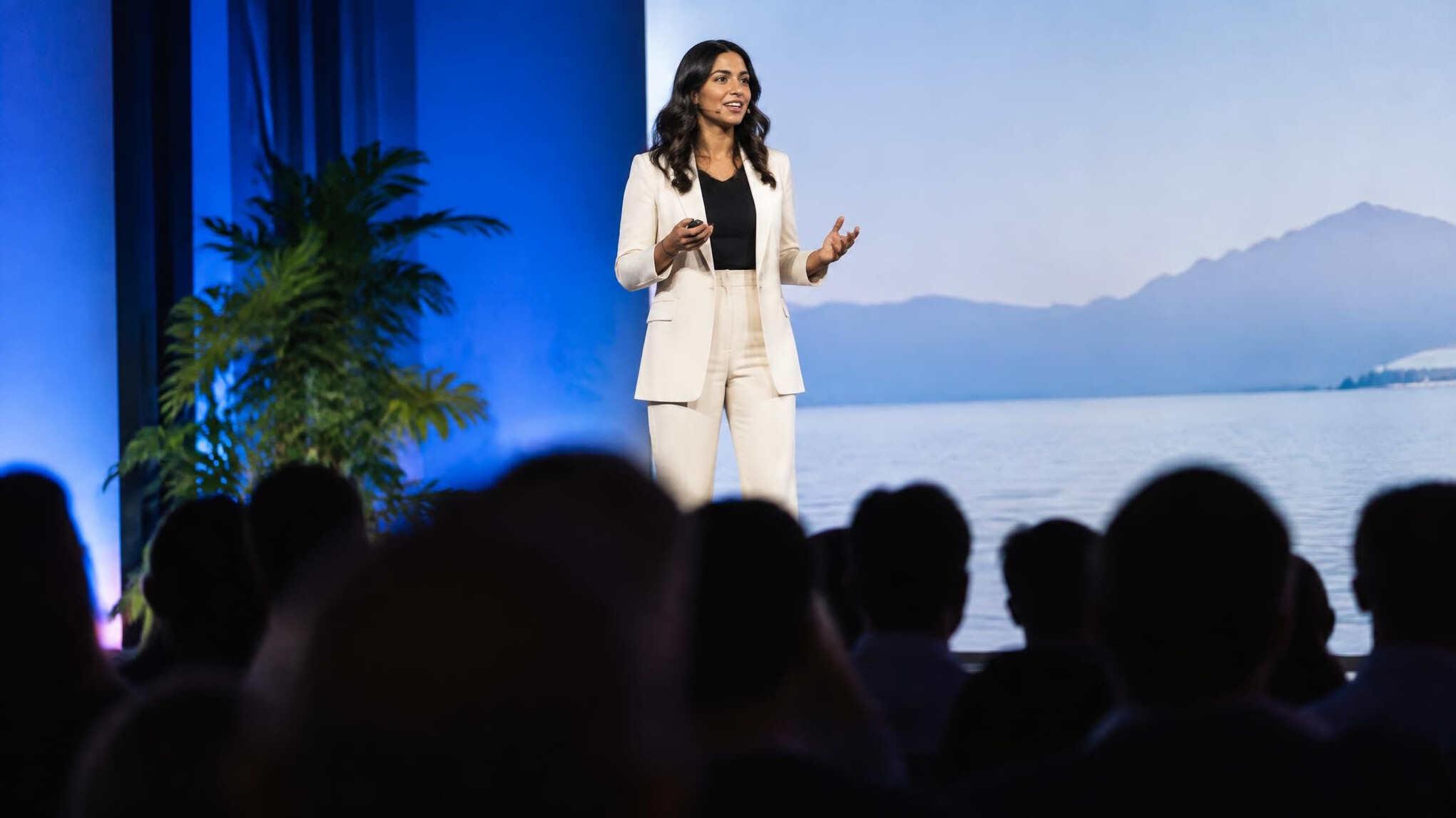 Speaker presenting on stage at a public speaking event