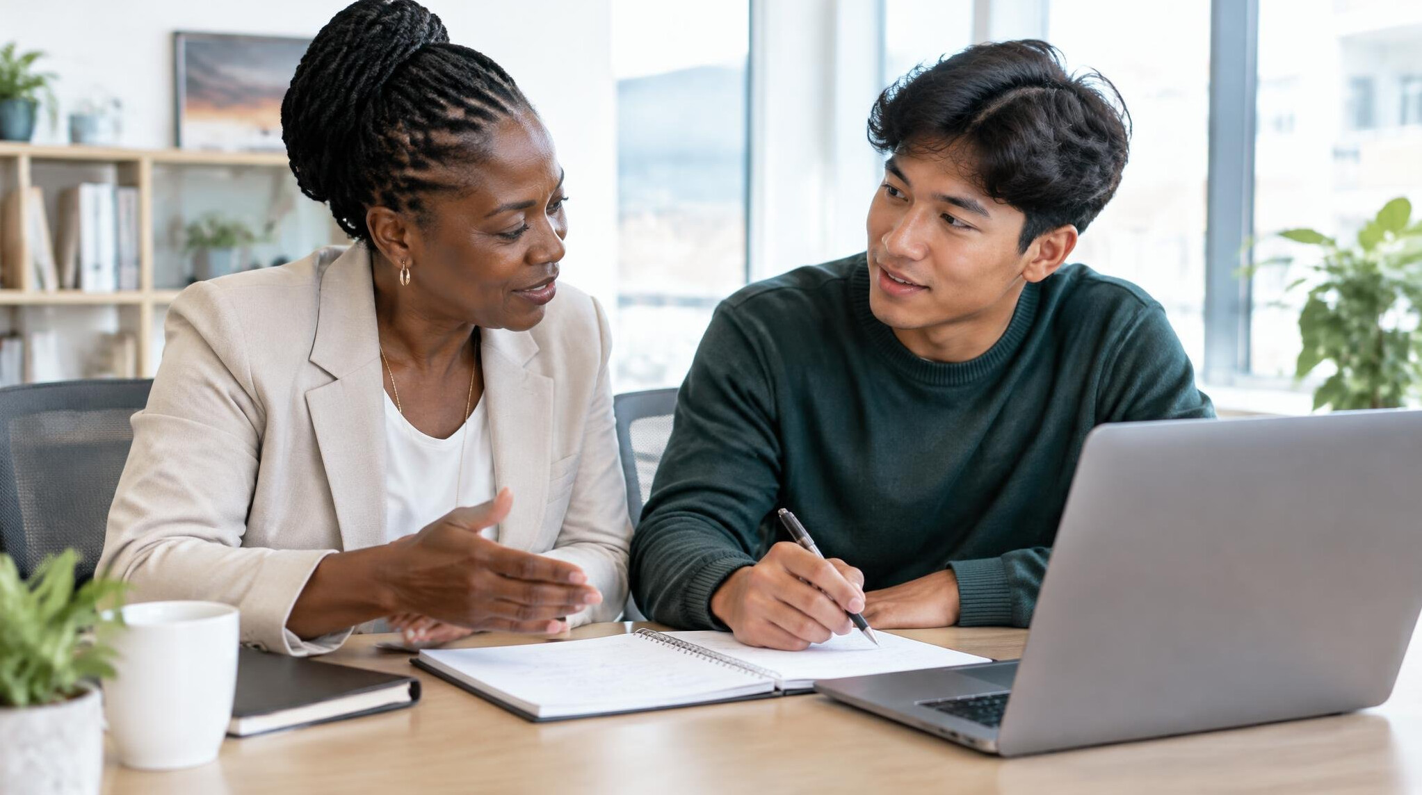 Mentor and mentee reviewing notes together at a desk